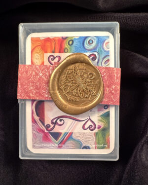 an oracle deck with a colorful background, wrapped with a ribbon and wax seal