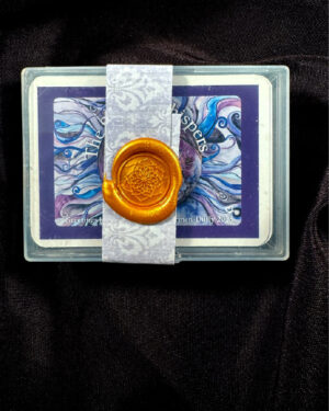The Spirit Whispers Oracle deck. Purple and blues supportng this deck. with a feminine figure in the middle. The deck is sealed with a wax seal